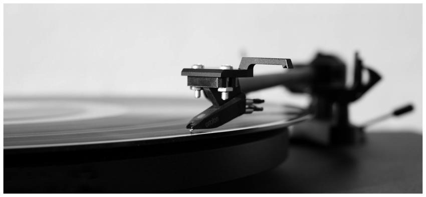 Black and white photo of a record player needle on