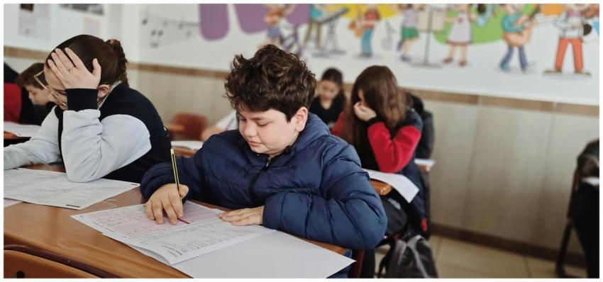 A group of children taking a test with focus and c