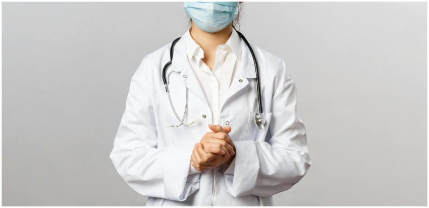 Healthcare professional wearing a mask and lab coa