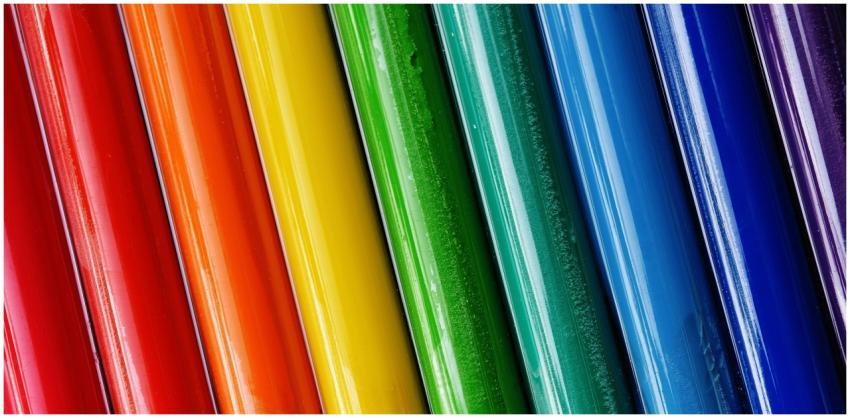 Close-up of brightly colored paint tubes arranged