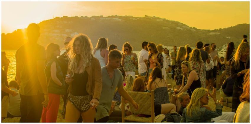 A lively gathering of people enjoying a sunset par