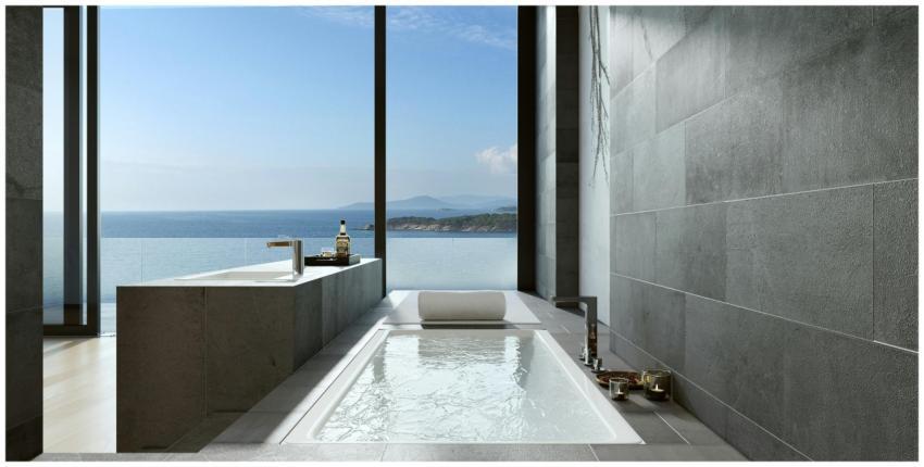 Luxurious minimalist bathroom with ocean view thro