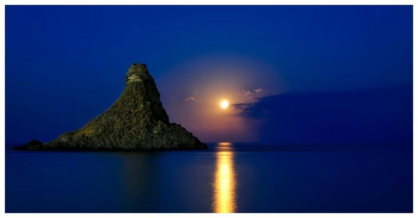 Peaceful sunset over the ocean with rock formation