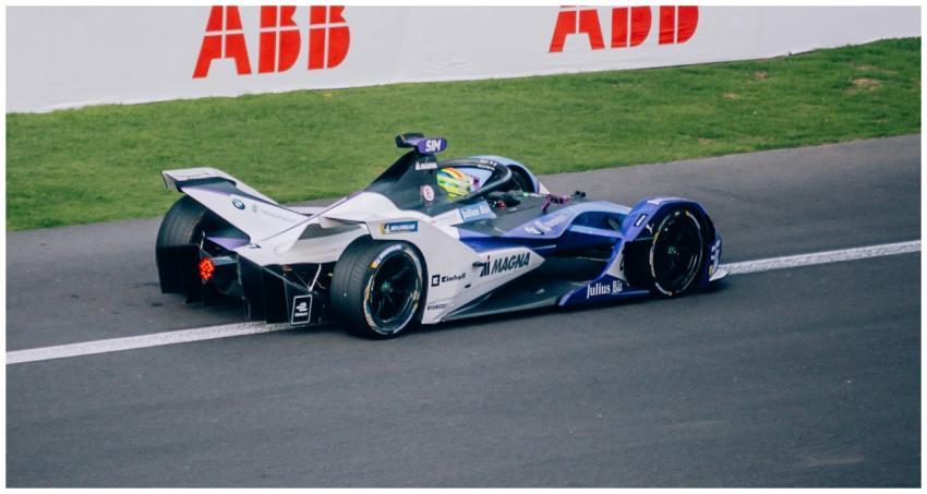 A Formula E race car speeds on track at a racing e