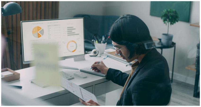 Business person reviewing analytics and charts at