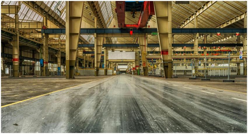 Wide view of an empty industrial warehouse with vi