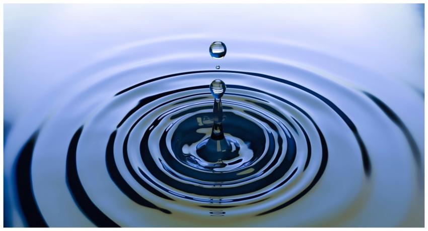 A stunning close-up of a water droplet creating ri