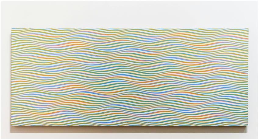 Colorful abstract wave pattern painting on a wall,