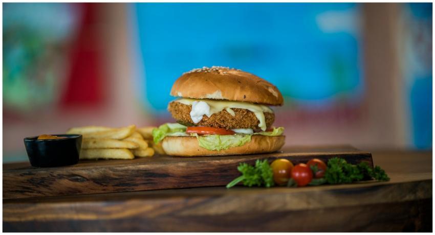 Close-up of a chicken burger with fresh vegetables