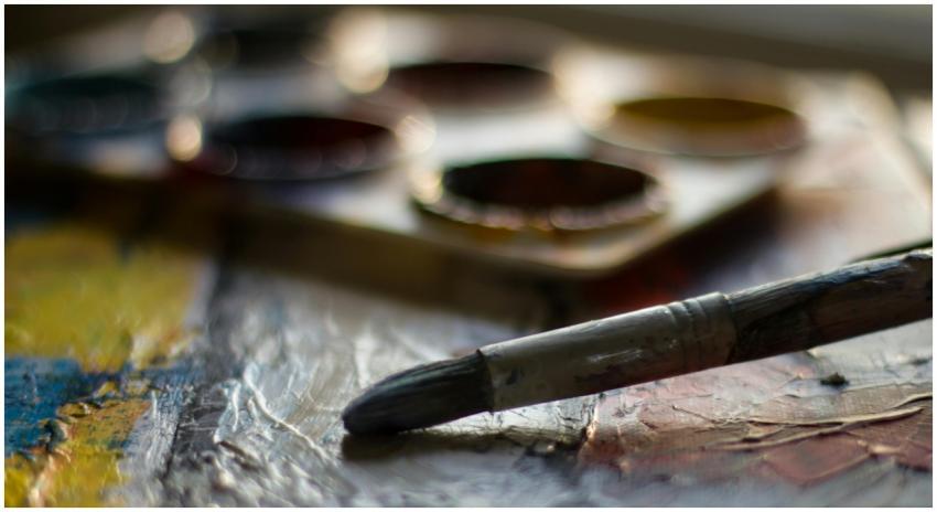 Artistic close-up of a paintbrush and palette capt