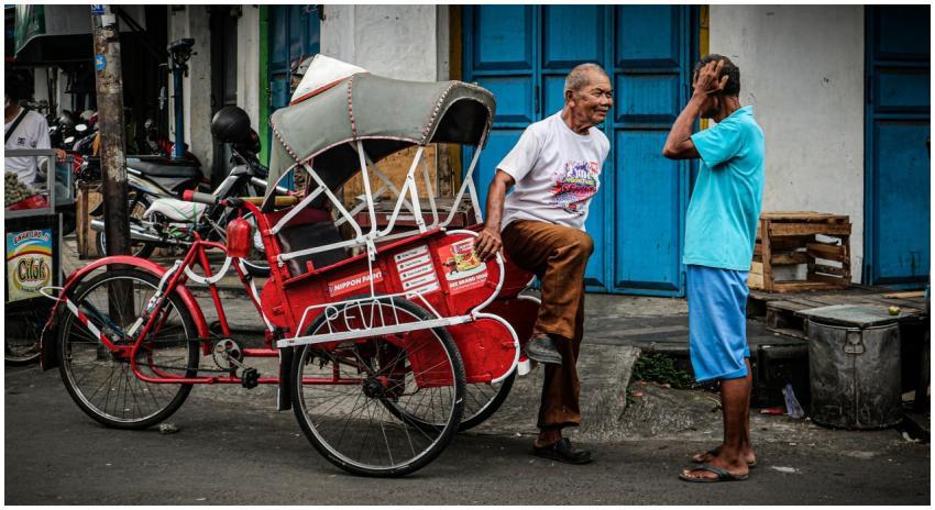 Two men in a lively conversation next to a vibrant