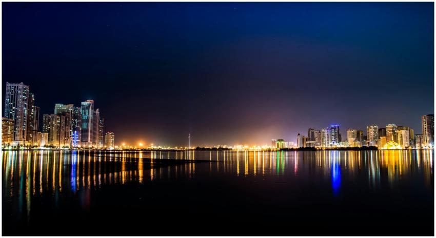 Stunning night view of a city skyline reflecting o