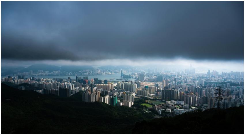 Aerial view of Hong Kong's skyline under dark clou