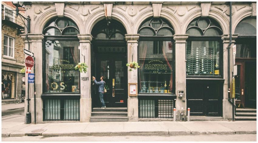 A historic restaurant facade with arched windows i