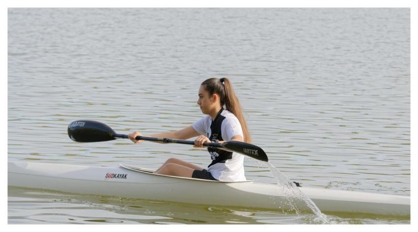 Woman Rowing Kayak Boat