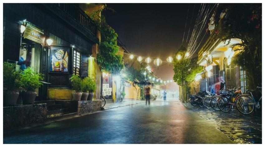 A peaceful street scene at night with hanging lant