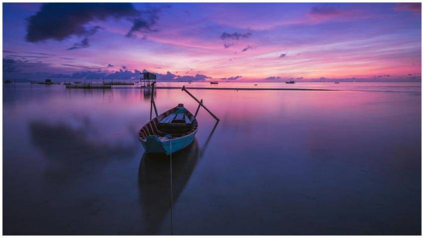 A tranquil sunrise over a tropical ocean with a so