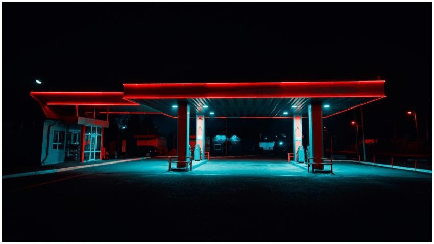 Urban gas station illuminated with vibrant neon li