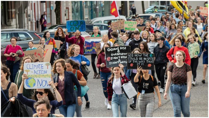 A vibrant climate march with diverse group holding