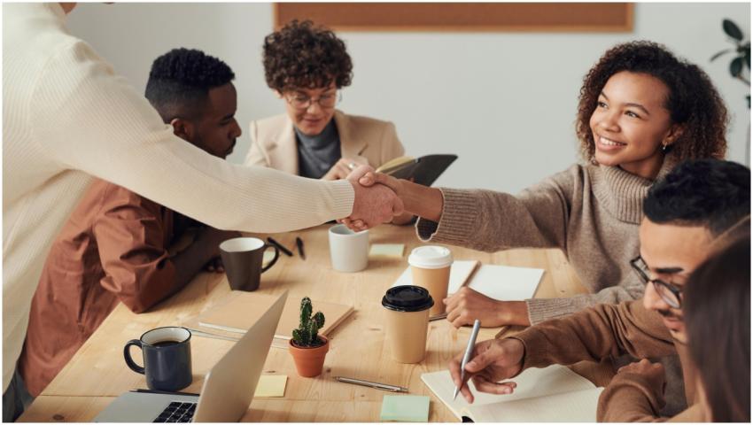 Colleagues collaborating indoors, sharing smiles,