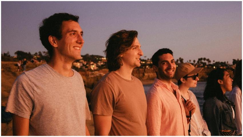 A group of friends watching the sunset at the beac