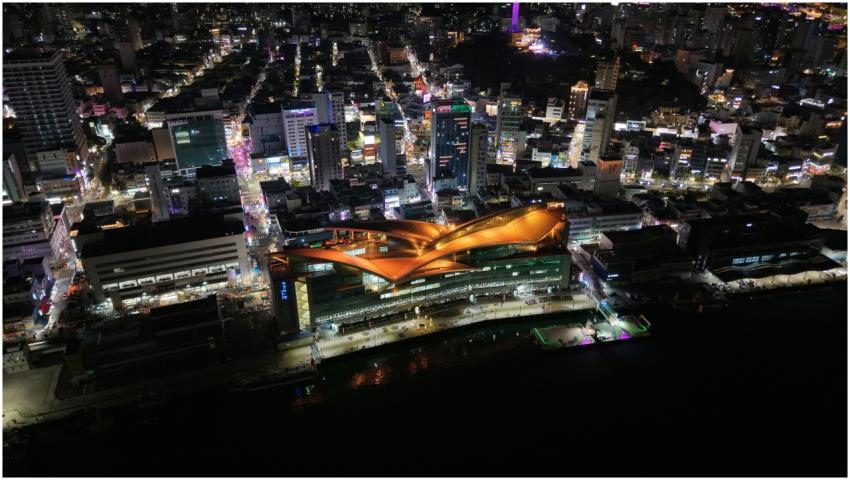 Vibrant night aerial view of Busan city illuminate