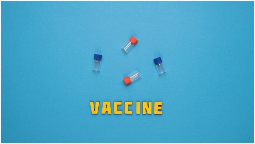 Three small vials and the word 'VACCINE' on a blue