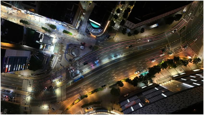A vibrant aerial view of illuminated streets and t