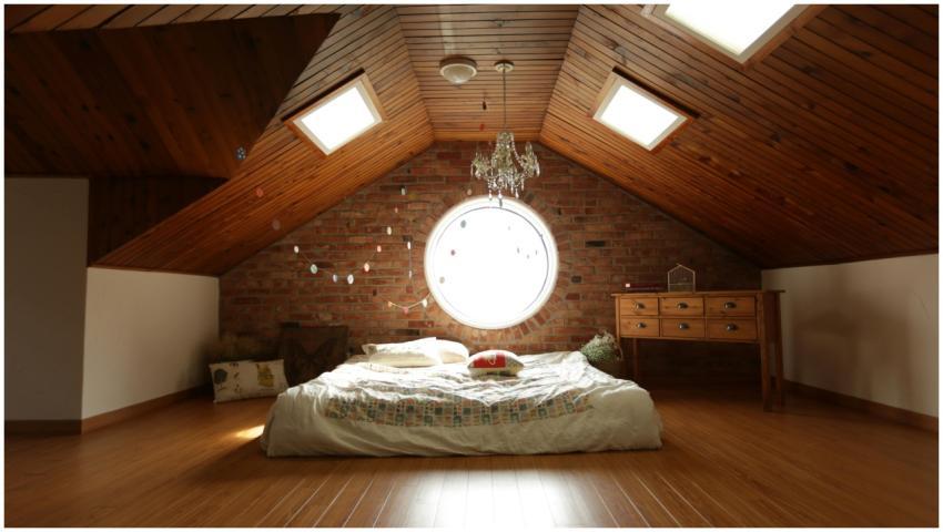 A warm and inviting attic bedroom featuring a uniq