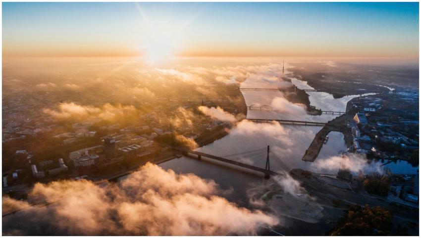 Stunning aerial sunrise view over a city with brid