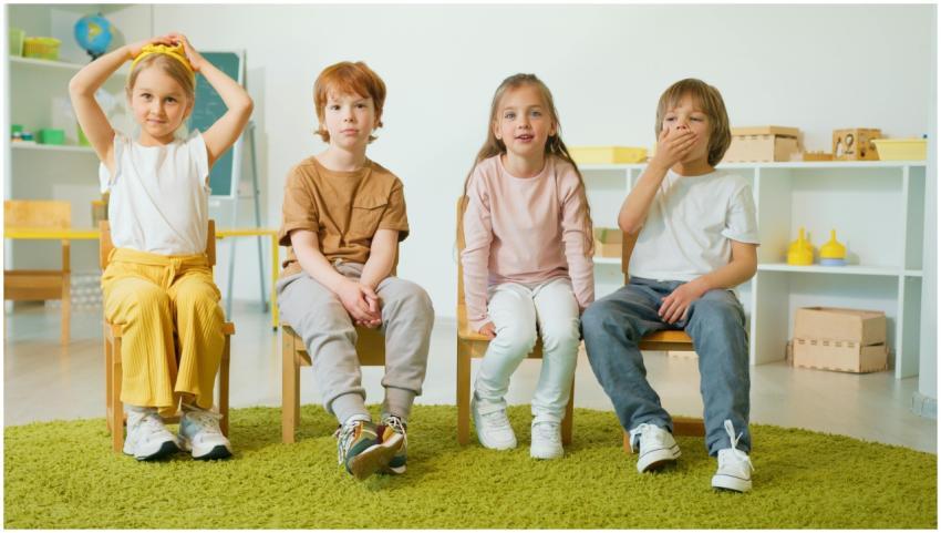 Group of children sitting on chairs in a classroom