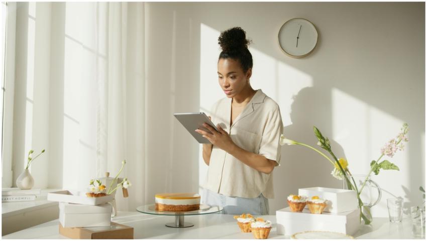 A woman using a tablet in a bright and modern kitc