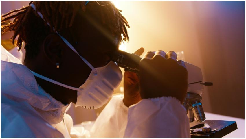Scientist wearing protective gear examining sample