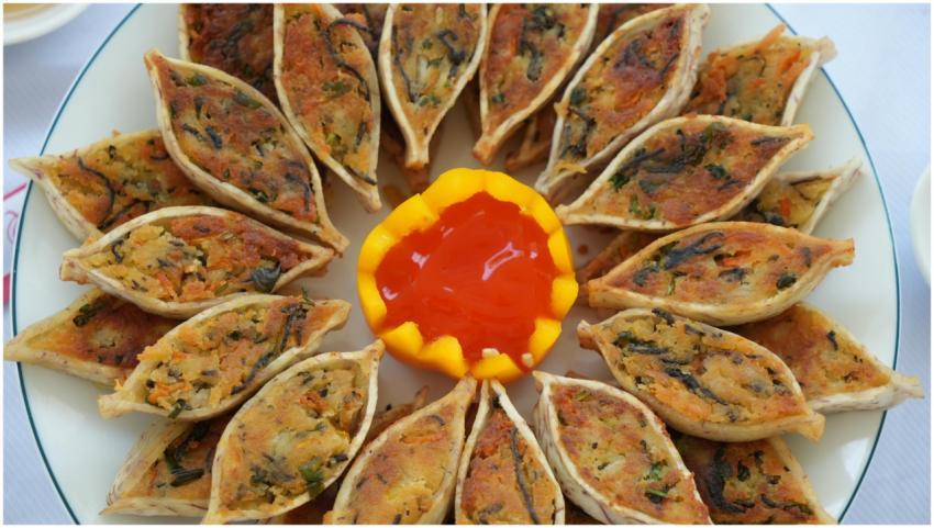 A plate of vegan dumplings arranged with sweet chi