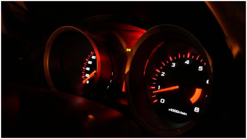 A detailed view of illuminated car gauges on the d