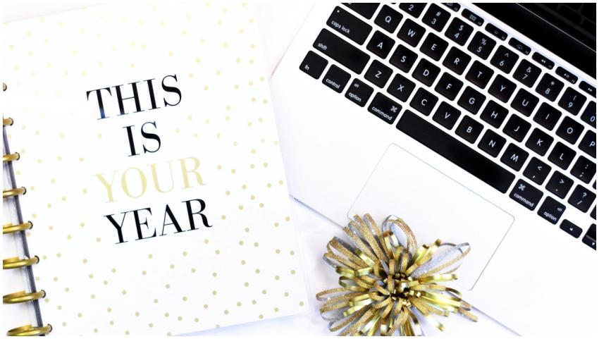 A stylish desk setup featuring a laptop and a moti