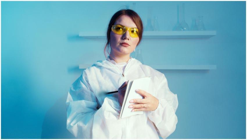 Confident female scientist in a lab coat taking no