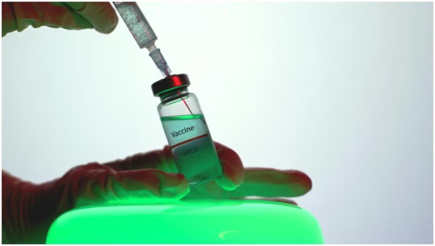 Syringe drawing vaccine from vial, symbolizing imm
