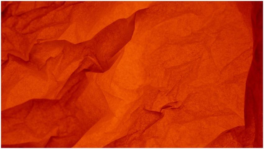 Abstract red crumpled paper texture with dynamic f
