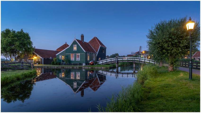 Scenic view of a charming house and bridge reflect