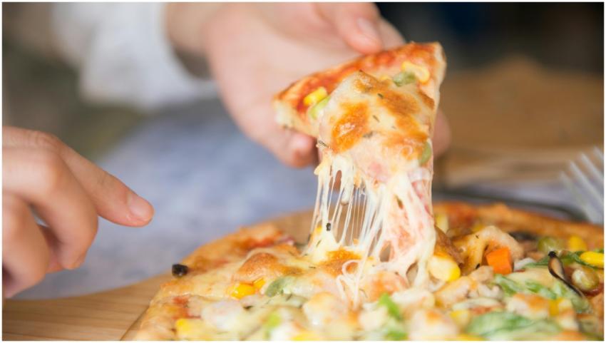 Appetizing close-up of a cheesy pizza slice with t