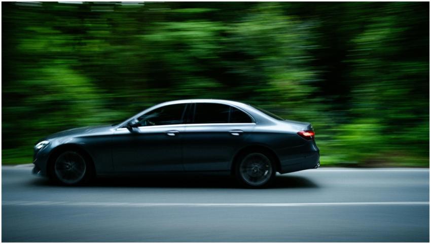 Dynamic shot of a sleek sedan speeding through a l