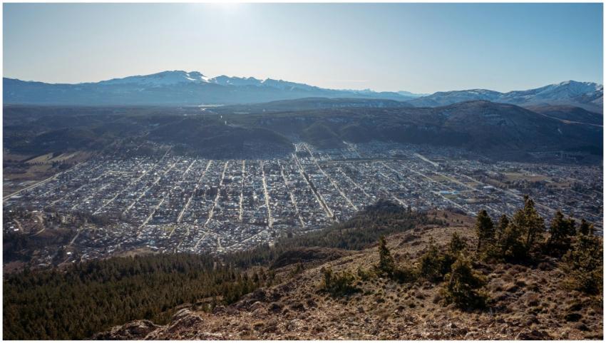 A sweeping aerial view of a city nestled in a moun
