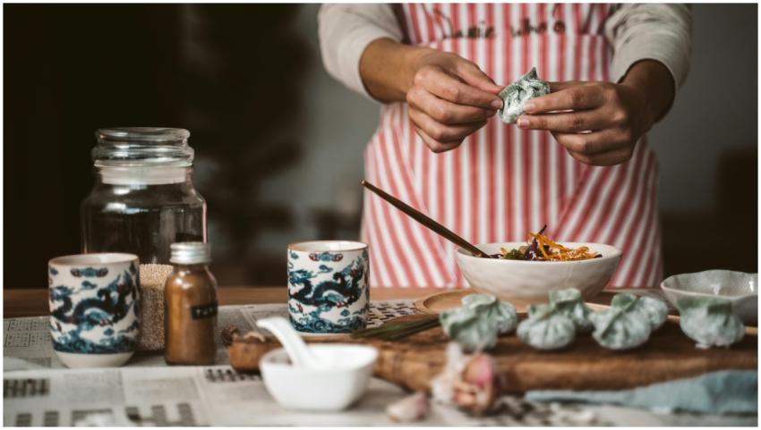 Close-up of hands making dumplings with ingredient
