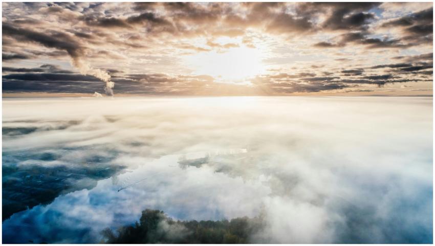 Dramatic aerial view of a cloudy landscape with su