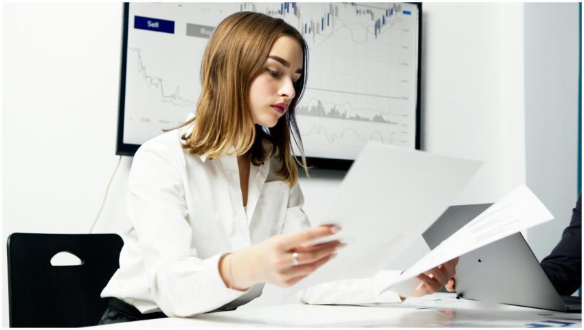 Focused woman analyzing financial reports in a mod
