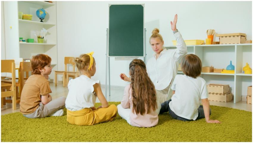 Preschool teacher interacting with children in a c