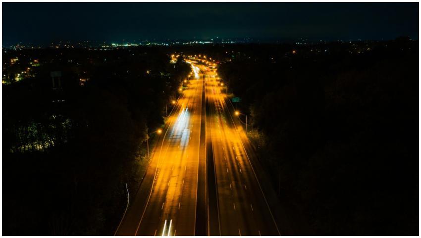 Aerial nighttime view of a brightly lit highway wi