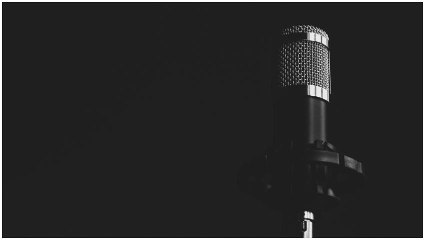 Close-up view of a studio microphone against a dar