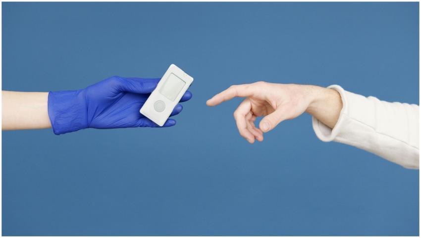 A medical professional hands a glucometer to a pat